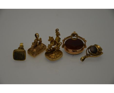 Five various 9ct yellow gold stone set seal fobs including St George and the Dragon, blood stone and cornelian swivel, three-