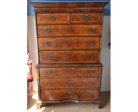 A reproduction George II crossbanded walnut chest on chest, with two short over six long graduated drawers with inverted star