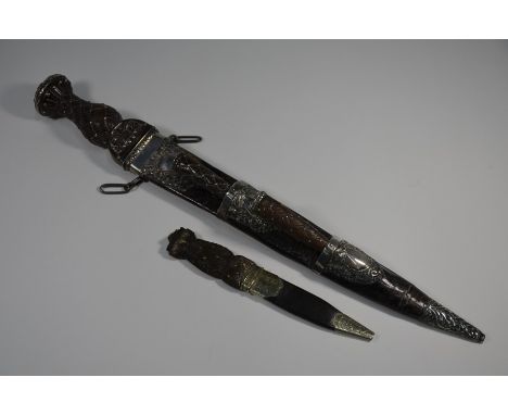 A Victorian Scottish dirk with 30 cm fullered blade by MacLeod of Edinburgh, on strapwork-carved wooden handle with unmarked 