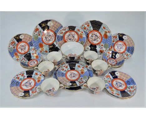 A part set of Victorian bone china Imari pattern tea-ware, including six two-handled trembleuse cups and a slop bowl bearing 