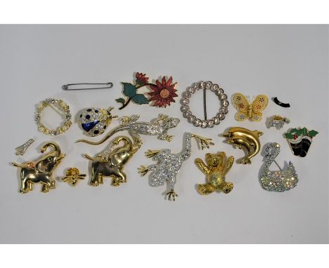 A collection of gilt-metal costume jewellery brooches including white paste-set leaping frog, white paste-set lizard, two whi