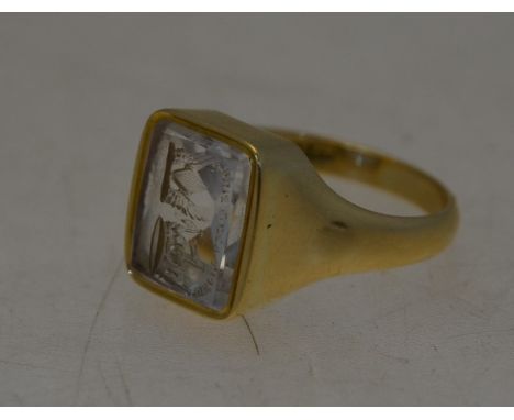 An 18ct yellow gold signet ring with rectangular rock crystal intaglio, size T/U, head 1 x 1.3 cm, 11.3g all inLight wear, su