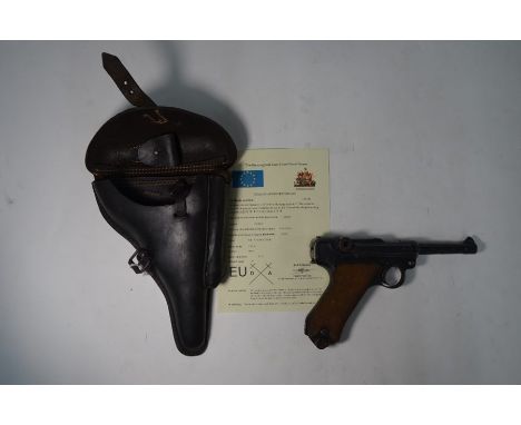 A World War I German Army Luger pistol with 8 cm barrel and hatched wood grip, no 8113, dated 1917, in original leather holst