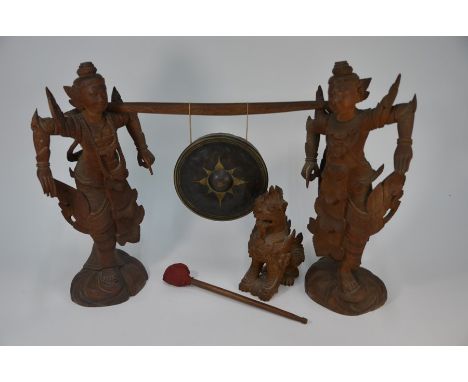 An early 20th century Burmese suspension gong, the circular metal gong with central boss and star flower decoration suspended