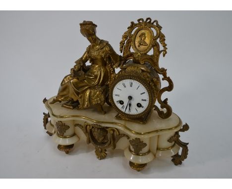 A late 19th century gilt-metal mounted alabaster drum mantel clock, the two train French movement with white enamelled dial, 