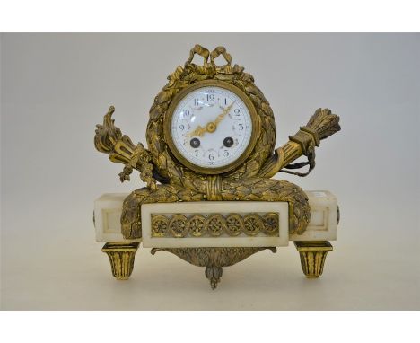 A 19th century Empire style gilt-metal and white marble mantel clock, the two train eight-day movement striking on a bell, wi