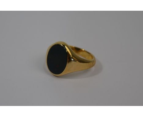 A 9ct yellow gold signet ring set with oval plain blood stone, size T/U, approx 7.7g all inLight wear/scratches only
