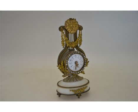 A late 19th century French drum clock within a lyre frame, on white onyx base, 20 cm high overall