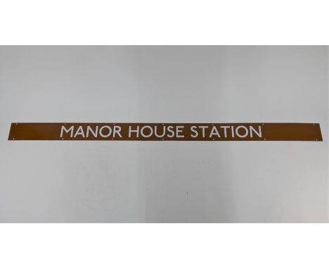 'Manor House Station', a vintage London Underground enamel sign, white lettering on brown, 164 cm x 10 cm