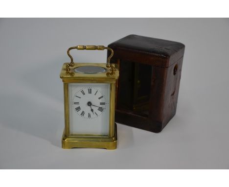 ACC Ltd - a lacquered brass small carriage clock with leather case (cracked to top), 12 cm high overall