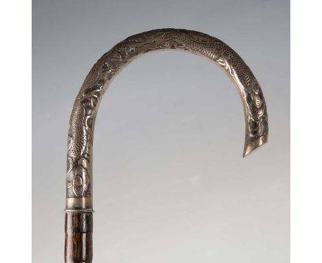 A late 19th/early 20th century Chinese palmette and silver handled walking cane, the handle chased with dragons amongst vapou