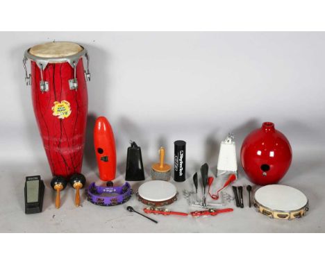 A collection of percussion instruments, including a Congo drum, a cabassa, two tambourines and a Meinl Salsa Guiro.