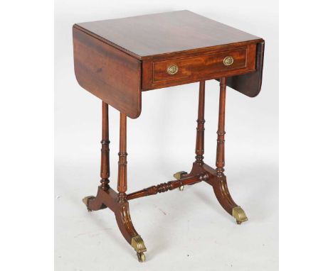 A William IV mahogany sofa table of small proportions, fitted with a single drawer and raised on tulip cusp carved supports, 
