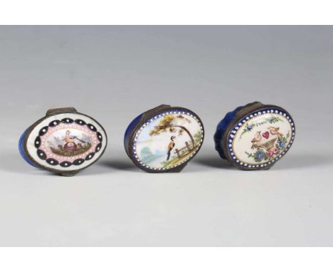 A group of three 18th century South Staffordshire enamel oval patch boxes, each lid painted with birds above blue glazed bodi