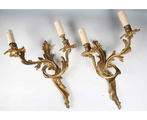 A pair of 20th century rococo style gilt brass twin-light wall sconces, height 35cm.