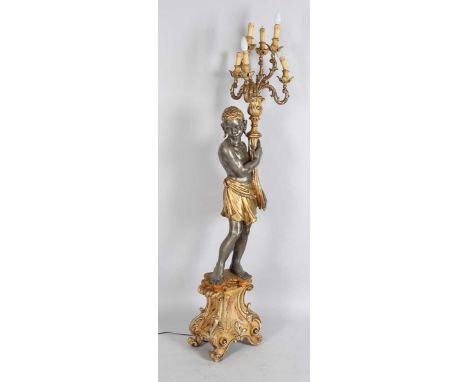 A 20th century Continental carved wood and gesso blackamoor floor light, the six scrolling branches supported by a standing m