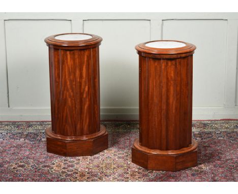 A PAIR OF VICTORIAN MAHOGANY AND MARBLE INSET BEDSIDE CUPBOARDS  LATE 19TH CENTURY The fluted bodies incorporating a cupboard