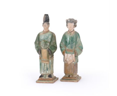 A PAIR OF CHINESE POTTERY AMBER AND GREEN GLAZED TILE-MAKER'S FIGURES MING DYNASTY  Modelled with detailed facial expressions