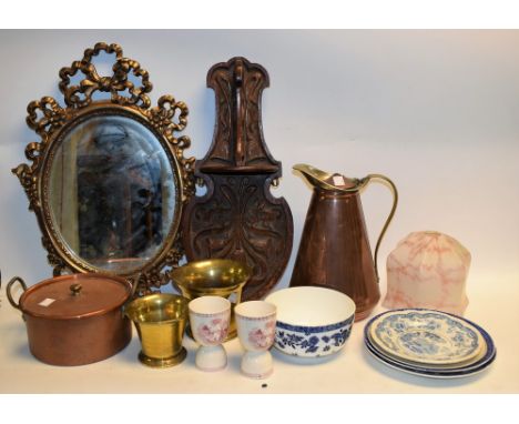 A carved oak wall hanging shelf; a late 18th early 19th century brass mortar; another similar; a set three coat and hat pegs;