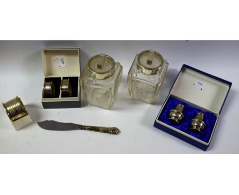 A pair silver napkin rings, engine turned, boxed; a single silver napkin ring, boxed; a pair silver pepperettes; a pair silve