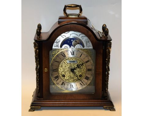 A Hermle mahogany veneered brass mounted reproduction bracket clock, the silvered chapter ring with Roman numerals, twin wind