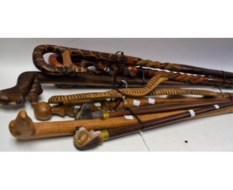 Walking Sticks - an African Tribal walking stick, the shaft and handle as a giraffe; others, Tribesmen, elephant, dog, horse 