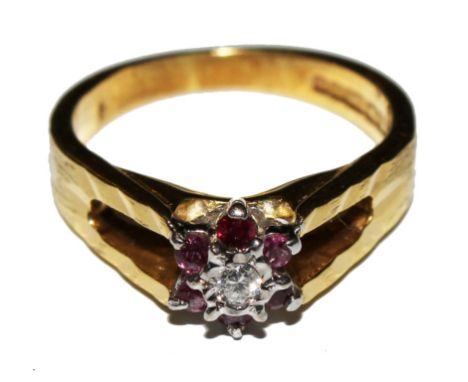 An 18 carat gold ruby and diamond cluster ring 