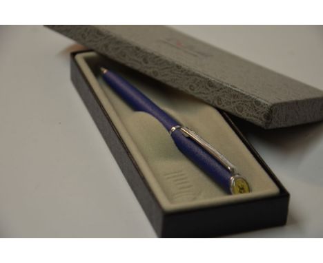 This blue Quill pen has the Rolls-Royce logo at the top. The logo is black with a white background. This pen was made in the 