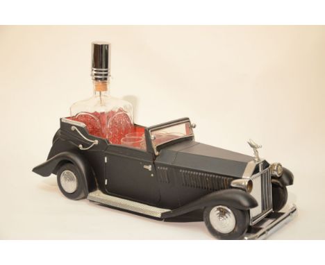 Your are bidding on a highly collectible Rolls Royce item- a metal car music box that holds a decanter and a set of 6 glasses