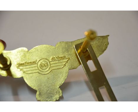 Measures 4 1/4 inches from wing tip to wing tip. Made of heavy gigh gloss brass. Includes a sturdy mounting bracket.