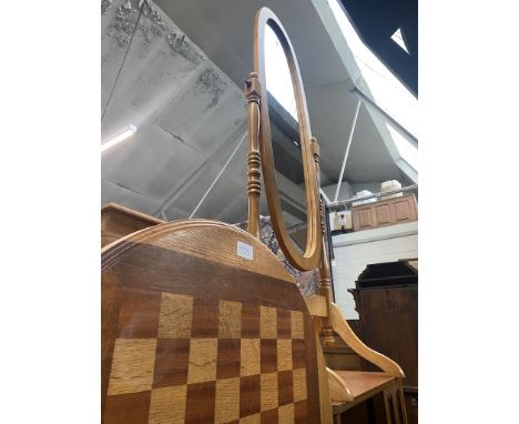 A light wood cheval mirror and a chess top table. 