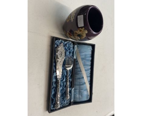 Silver plated boxed salmon server and a purple vase decorated with ladies and flowers. 