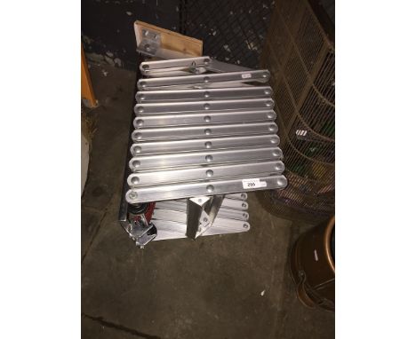 A scissor action loft ladder. 