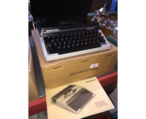 A Silver Reed portable typewriter with manual. 