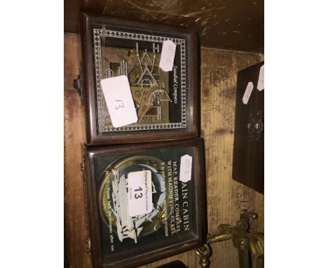 A cased compass and magnifying glass and a cased compass sundial 