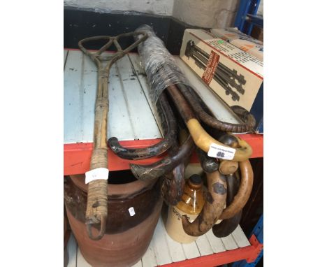 A bundle of 12 walking sticks to include 6 with silver collars and handles and a vintage beater. 