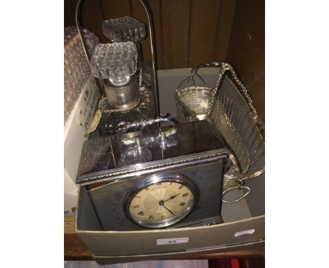 A collection of platedware to include clock, tantalus and a wine basket.Condition Report- The Tantalus is not marked.