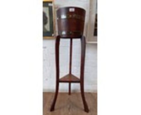 An oak and metal bound planter by R A Lister &amp; Co, height 91.5cm.