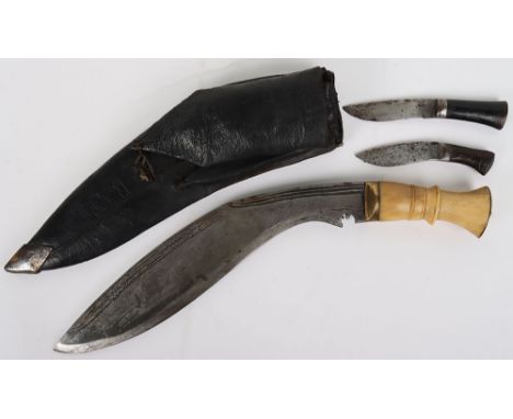 Large Indian Kukri Knife: Swollen blade with  decoration to  top edge , bone grip with  brass  pommel, in its leather covered