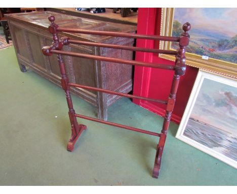 A 20th Century mahogany five bar towel rail with finial tops over turned supports