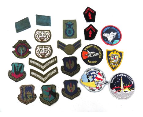 A quantity of military insignia including staybrites, US patches, together with a WWII era embroidered Royal Army Ordnance Co