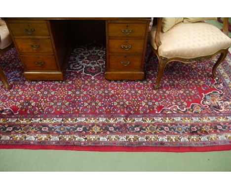 A vintage Persian Hamedan rug (300cm x 200cm), red ground and multiple borders