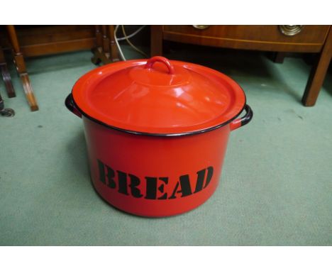 A large red enamel bread bin 31cm diameter 