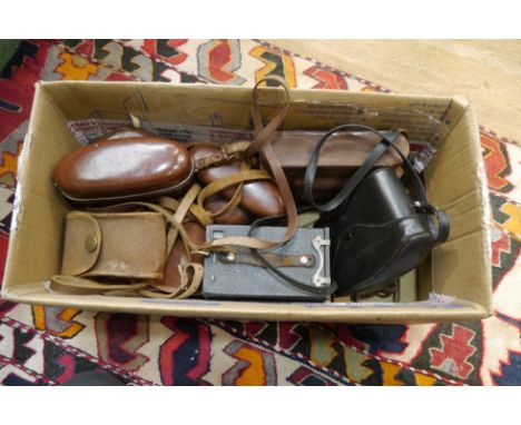 A box of vintage cameras including Rolleiflex SL35 ME and Zeiss Ikon Contaflex