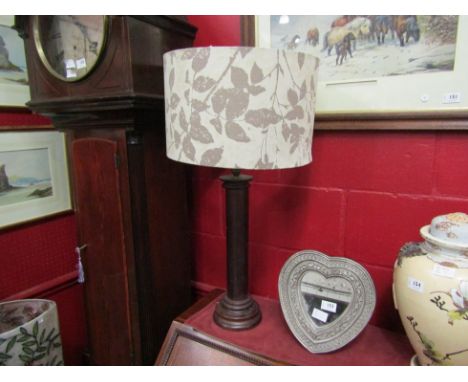 A large turned wooden lamp base with shade 