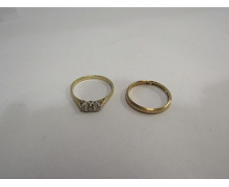 A 9ct gold band and a 9ct gold ring set with cubic zirconia 