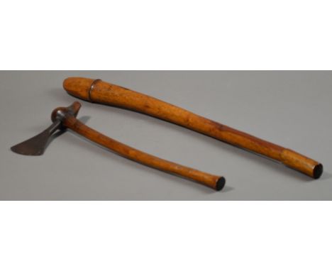A hardwood club in the form of an oosik, length 70cm; an iron bladed axe, length 48cm (2). CONDITION REPORT: Good condition, 