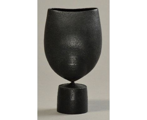 HANS COPER (1920-1981); a lobed stoneware ovoid form, pinned to drum base, burnished black slip, impressed HC mark, made 1975