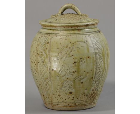 JIM MALONE (born 1946); a stoneware jar and cover, incised with fish motifs, green ash glaze, impressed JM mark, height 29cm.