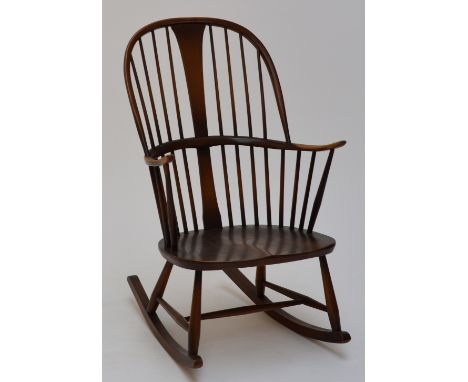 Ercol; a high hoop back Windsor style rocking elbow chair, height 102cm.
